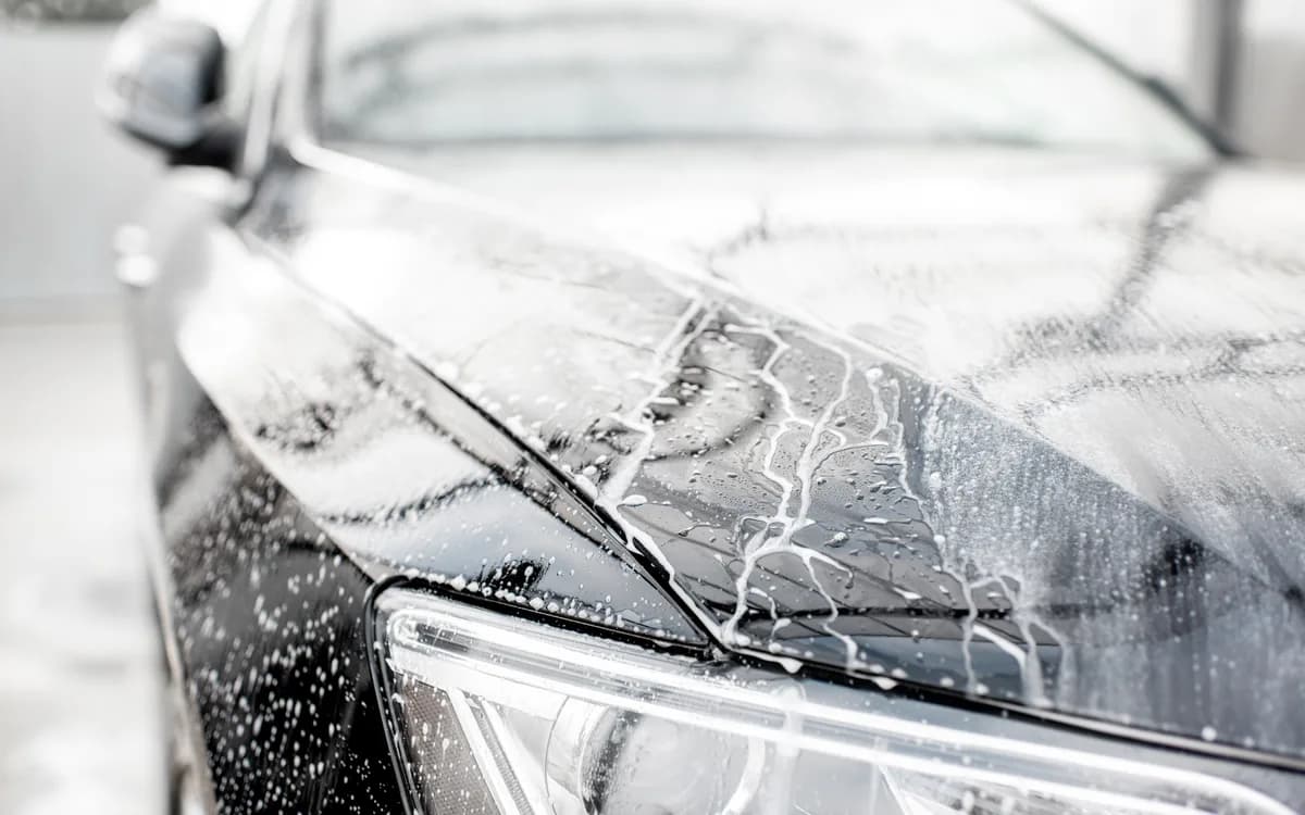 Car bonnet covered with cleaning foam during an exterior wash