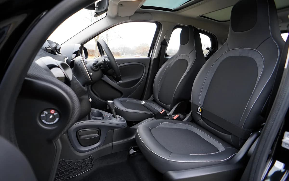 Clean car interior with front seats, dashboard and carpets visible