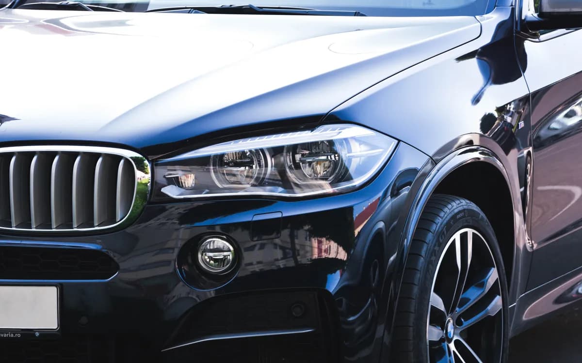 Glossy protected paintwork on the front of a dark vehicle