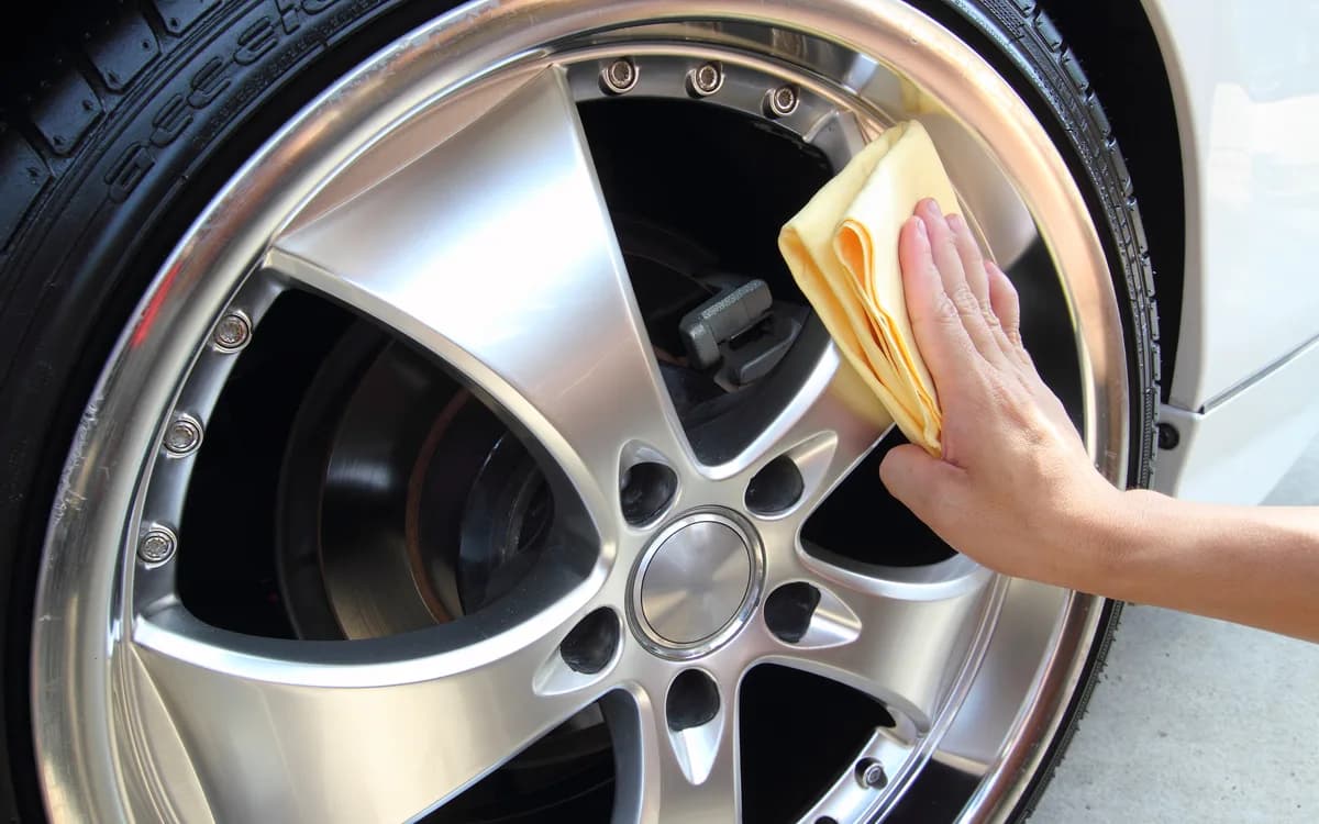 Alloy wheel being cleaned and polished by hand