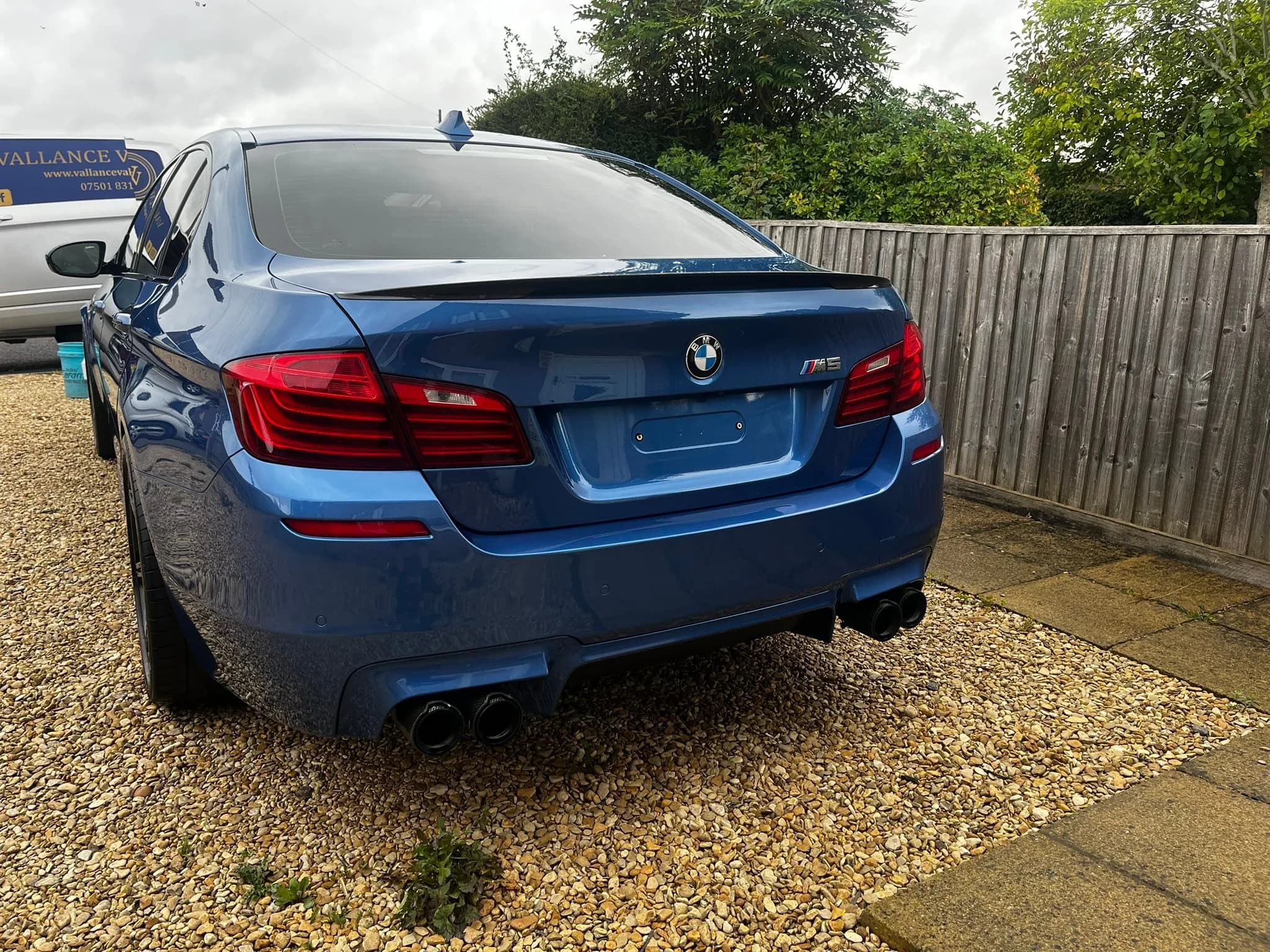 Grey car photographed from the rear